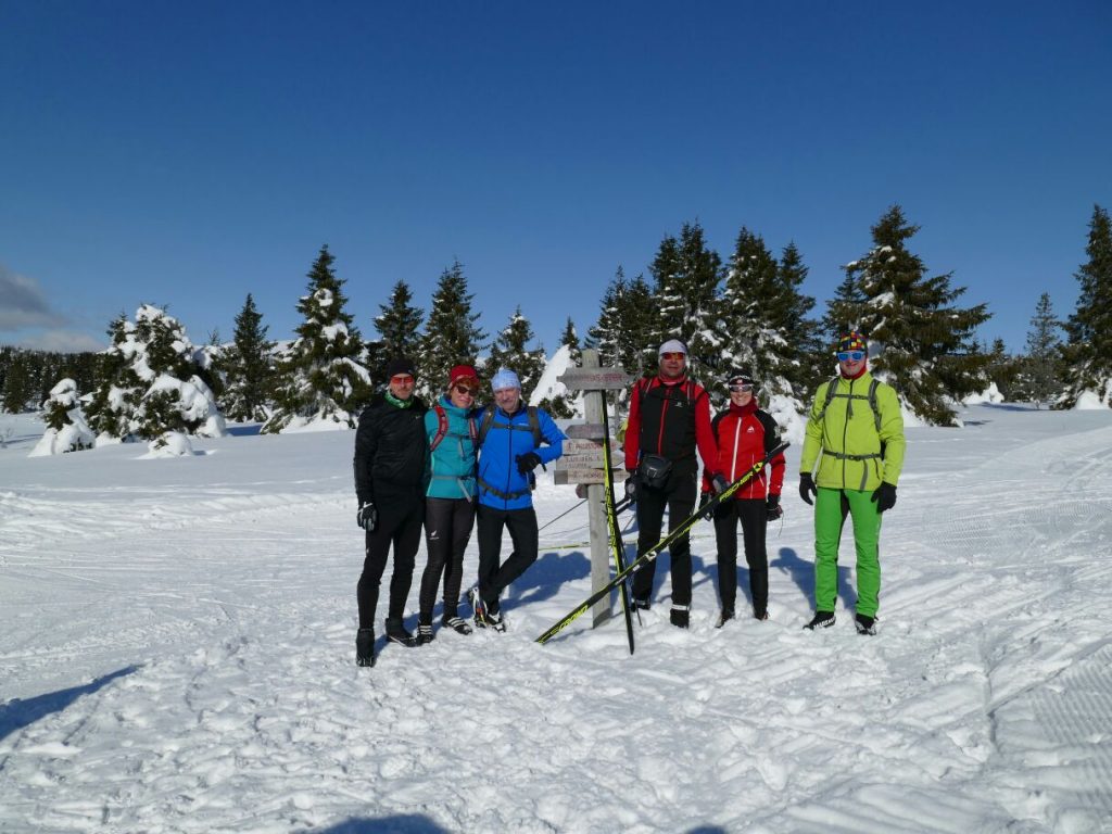 Die Skiläuferinnen und -läufer des Wintersportvereins Ilmenau an einem Wegweier an der Birkebeiner-Loipe. 